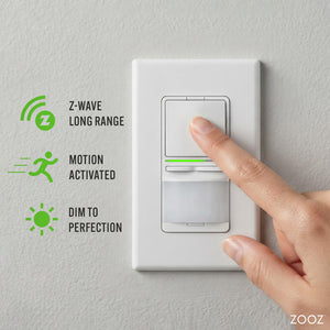A white smart light switch with a motion sensor panel, shown on a textured wall with a finger pressing the top button. Green icons and text on the left highlight features: Z-Wave long range, motion activated, and dim to perfection.